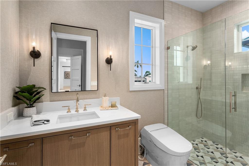 835 11th Avenue South Naples, FL 34102 - Photo 27 of 31 a bathroom with a sink toilet and shower
