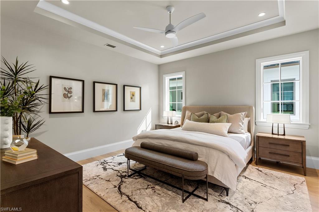 835 11th Avenue South Naples, FL 34102 - Photo 28 of 31 a bedroom with a large bed and a table