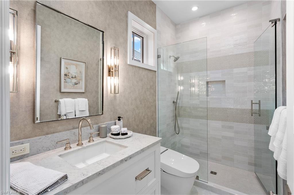 835 11th Avenue South Naples, FL 34102 - Photo 29 of 31 a bathroom with a sink a toilet and shower