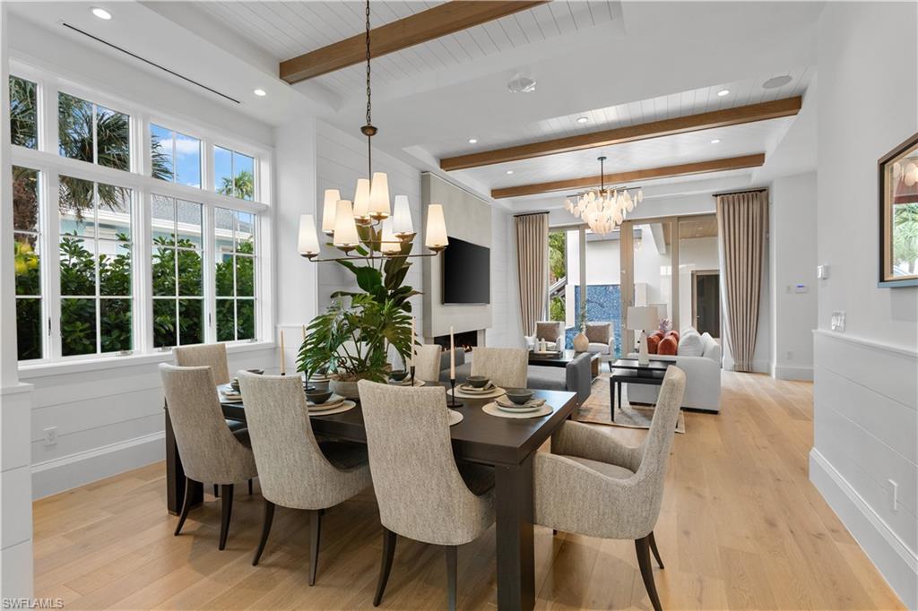 835 11th Avenue South Naples, FL 34102 - Photo 5 of 31 a view of a dining room with furniture window and wooden floor