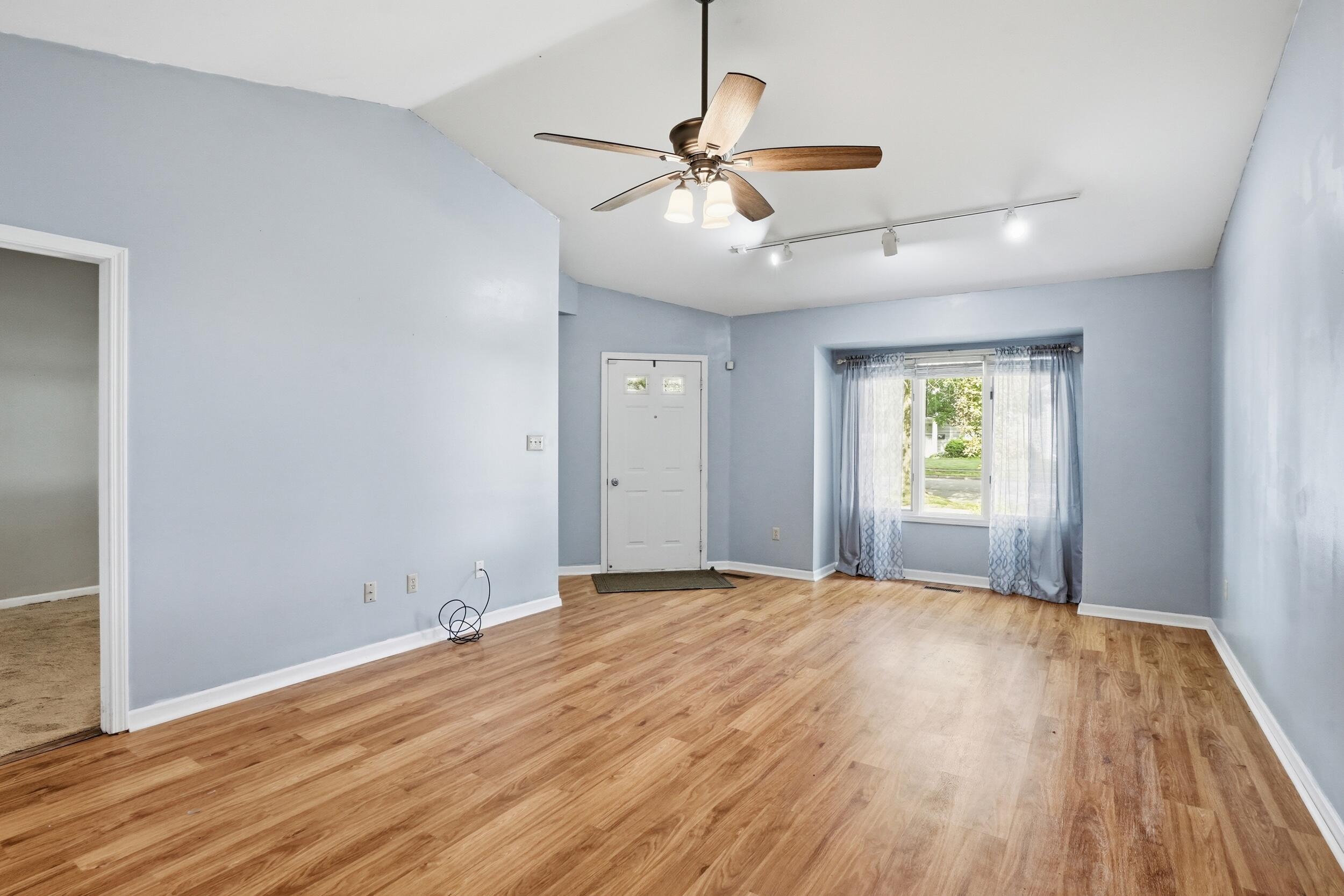 225 Clinton Street Lowell, IN 46356 - Photo 5 of 22 wooden floor in an empty room with a window