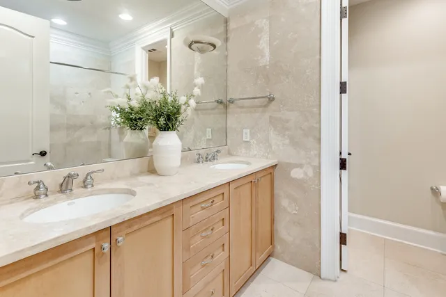 a bathroom with a granite countertop sink a mirror and a shower