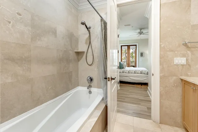 a en suite bathroom with a tub shower and sink