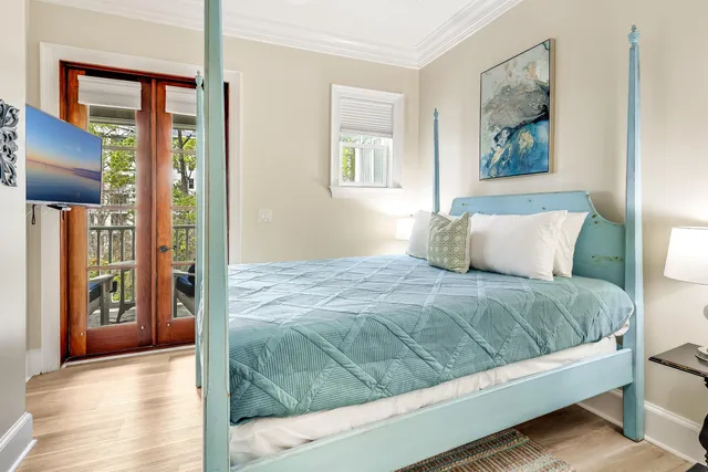 a bedroom with a large bed and a painting on the wall