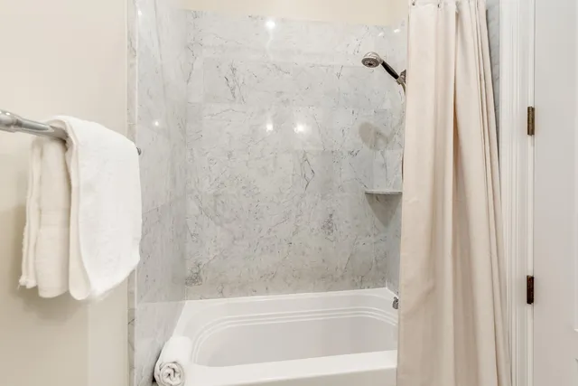 a bathroom with a tub and shower