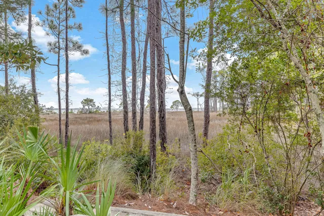 a view of a brick house with large windows