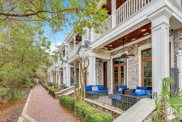 a front view of a house with outdoor seating and plants