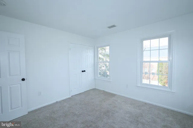 a view of an empty room with a fireplace