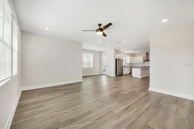 a kitchen with a refrigerator sink and cabinets