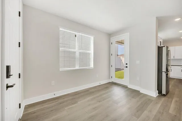 wooden floor in an empty room with a window