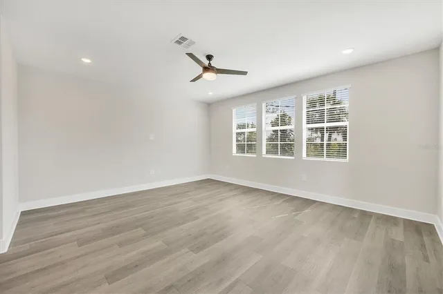 wooden floor in an empty room with a window