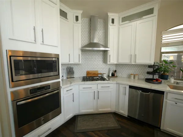 a kitchen with a sink stove and cabinets