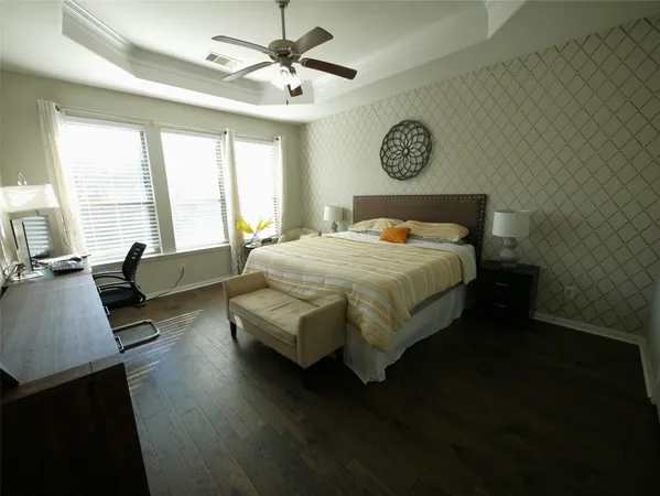 a bedroom with a bed window and a table in it
