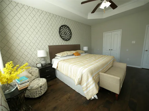 a bed sitting in a bedroom next to a lamp