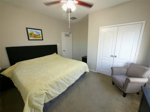a bed sitting in a bedroom and chandelier