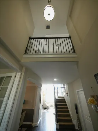 a view of entryway and hall with wooden floor