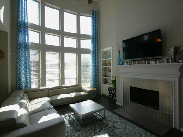 a living room with furniture a flat screen tv and a fireplace