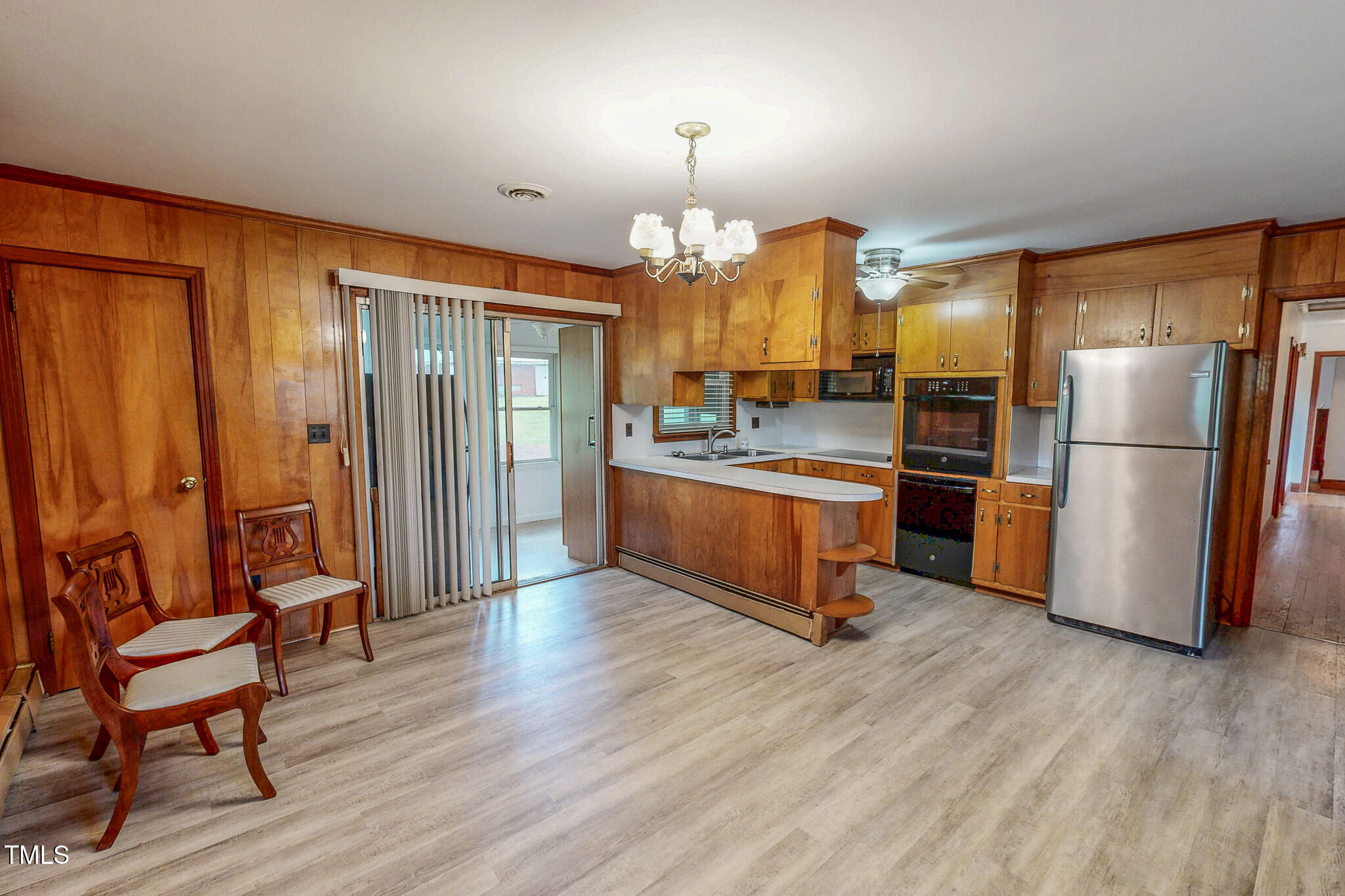9455 Boston Road Roxboro, NC 27574 - Photo 20 of 42 a kitchen with stainless steel appliances wooden floor and chairs