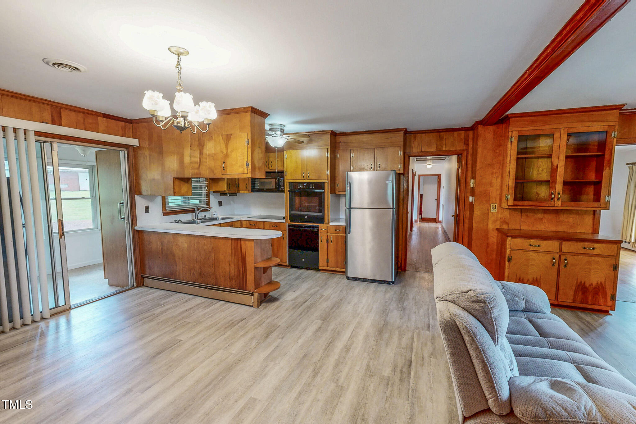 9455 Boston Road Roxboro, NC 27574 - Photo 22 of 42 a kitchen with stainless steel appliances kitchen island granite countertop a refrigerator a stove and a wooden floors