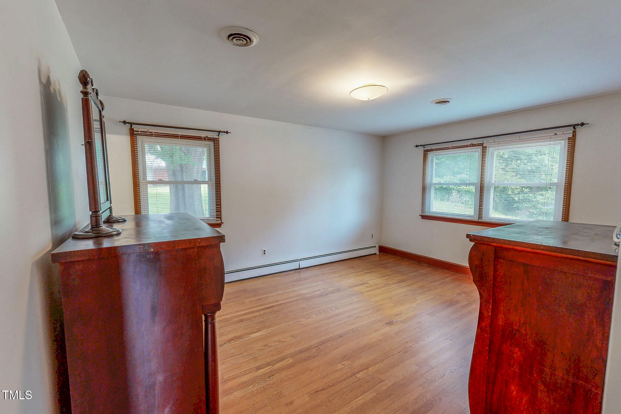 9455 Boston Road Roxboro, NC 27574 - Photo 26 of 42 an empty room with wooden floor and windows