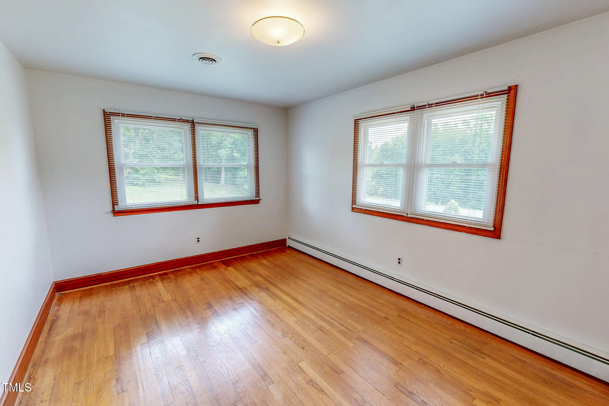 9455 Boston Road Roxboro, NC 27574 - Photo 30 of 42 a view of an empty room with wooden floor and a window