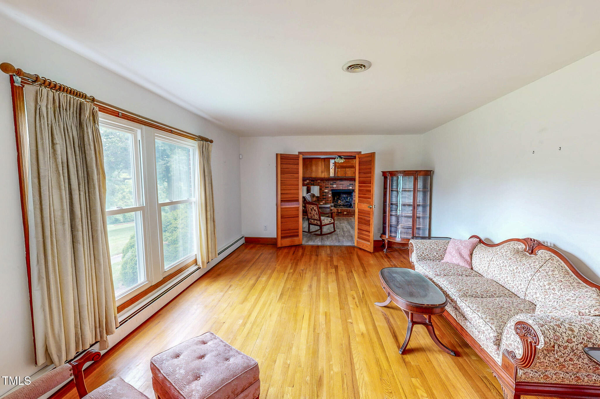 9455 Boston Road Roxboro, NC 27574 - Photo 3 of 42 a bed sitting in a bedroom next to a window