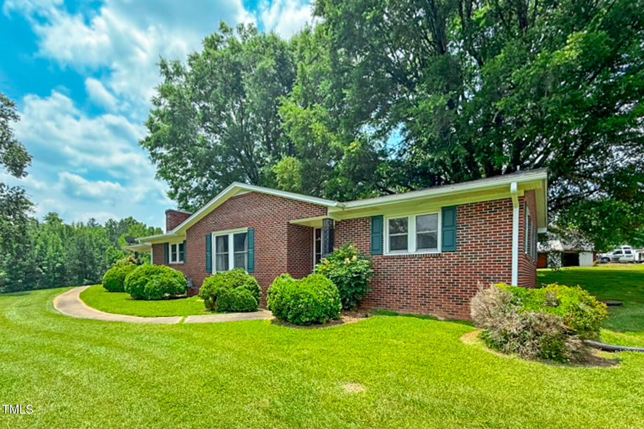 9455 Boston Road Roxboro, NC 27574 - Photo 7 of 42 a front view of a house with a yard and trees
