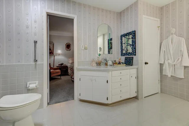 a bedroom with a bed and a dresser in it