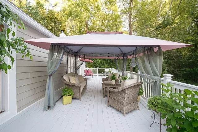 a patio with a table and chairs under an umbrella