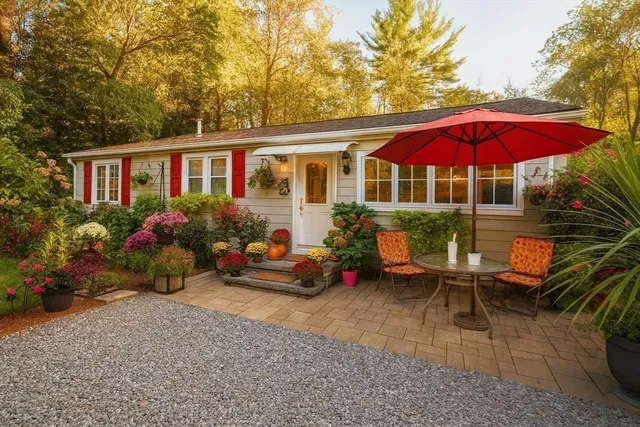 a view of a house with backyard sitting area and garden