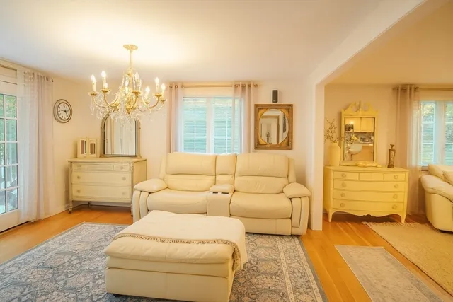a living room with furniture and a chandelier