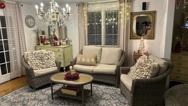a living room with furniture and a chandelier