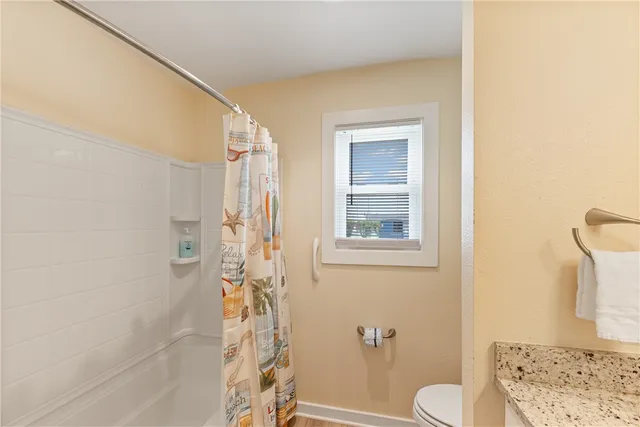 a bathroom with a toilet and shower