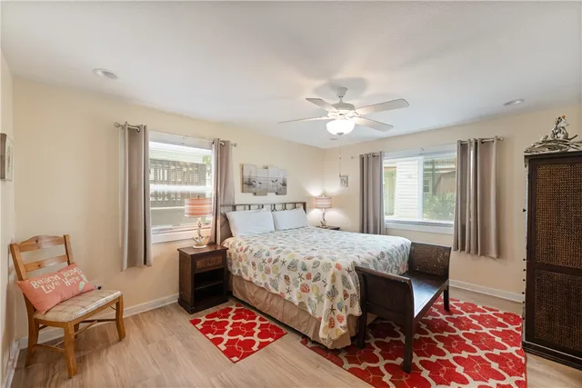 a bedroom with a bed chair and a window