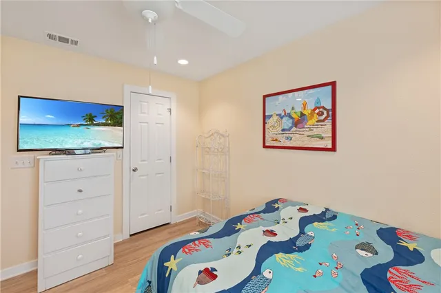 a bedroom with a bed and a dresser in it