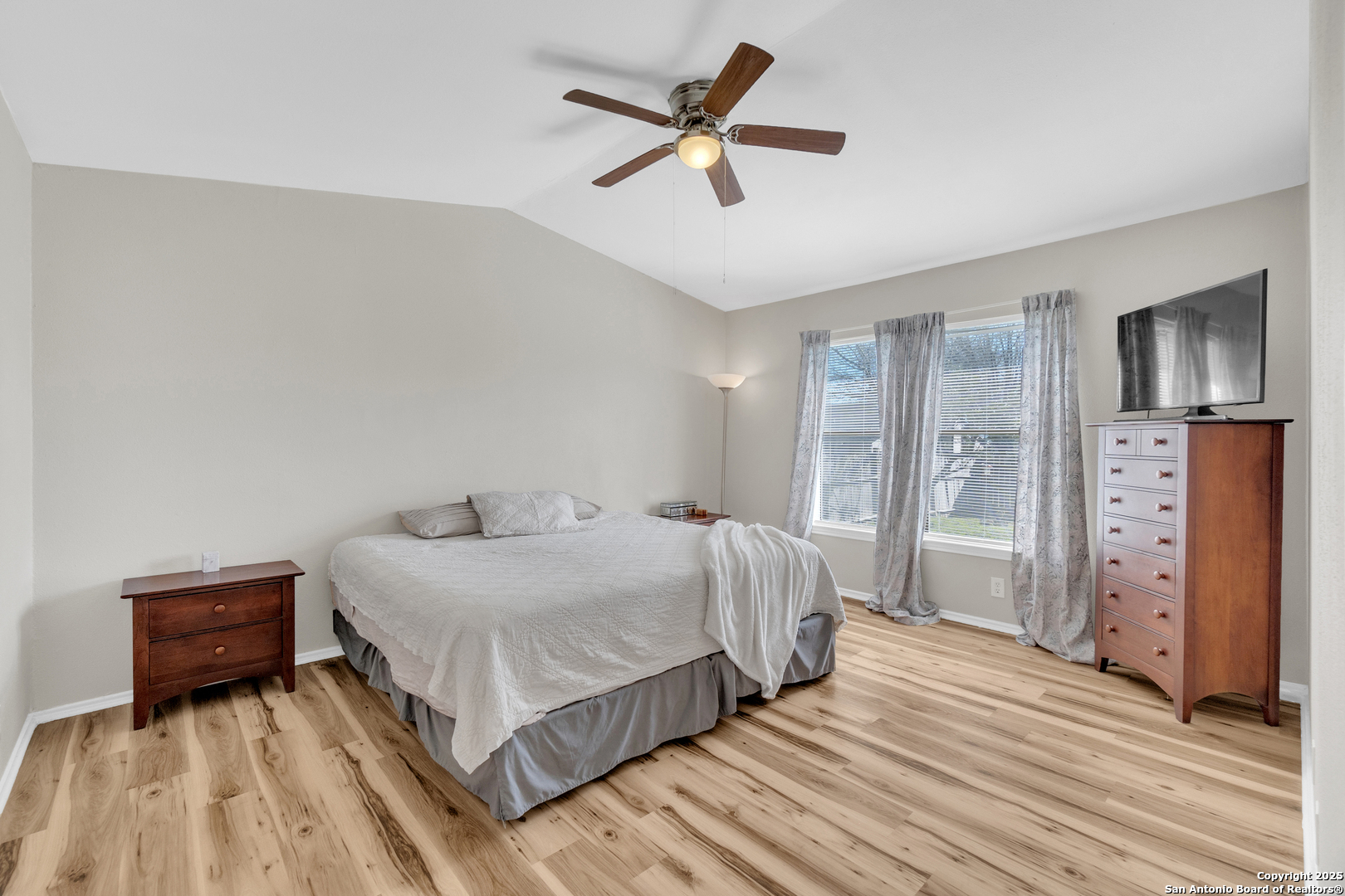 8722 Ridge Moon Drive San Antonio, TX 78239 - Photo 11 of 19 a bedroom with a bed and wooden floor