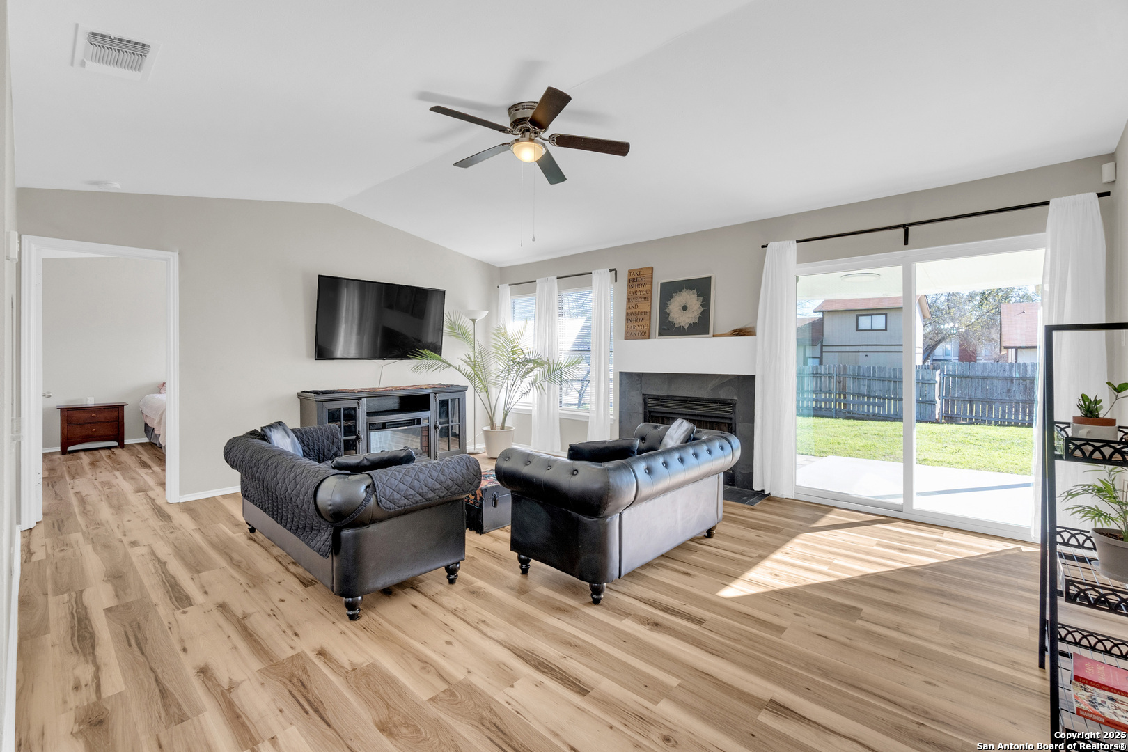 8722 Ridge Moon Drive San Antonio, TX 78239 - Photo 2 of 19 a living room with furniture fireplace and a flat screen tv