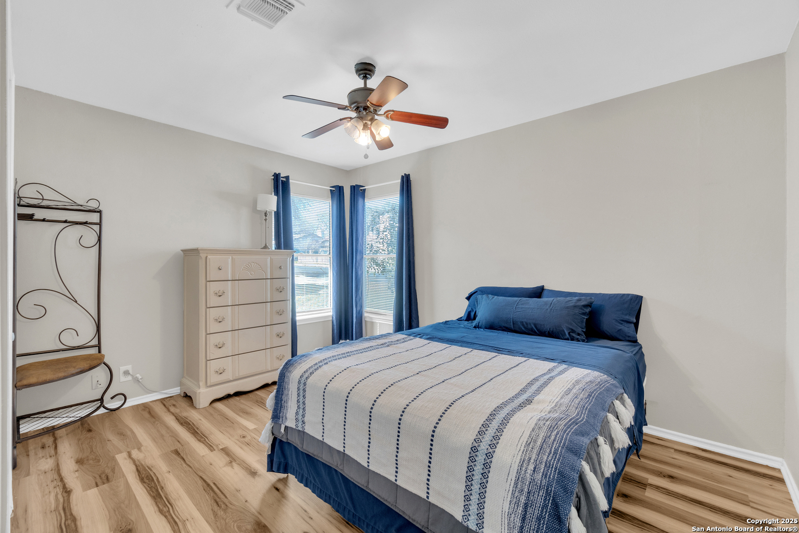 8722 Ridge Moon Drive San Antonio, TX 78239 - Photo 9 of 19 a bedroom with a bed a chandelier and closet