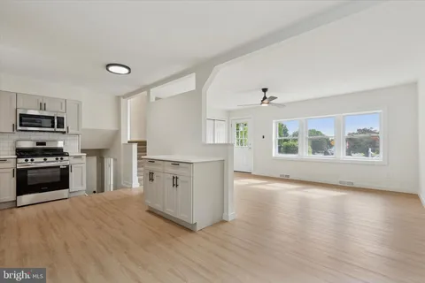 a kitchen with stainless steel appliances a stove top oven and a refrigerator