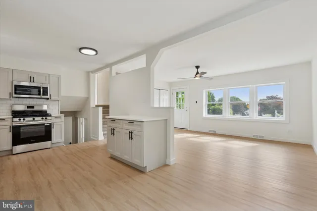 a kitchen with stainless steel appliances a stove top oven and a refrigerator