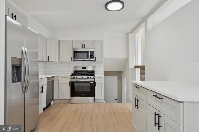 a kitchen with a refrigerator sink and stove