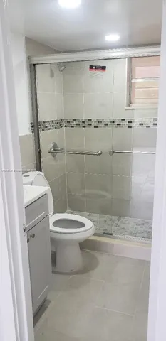 a white toilet sitting next to a bathroom sink