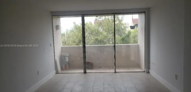 an empty room with sliding glass door and mountain view