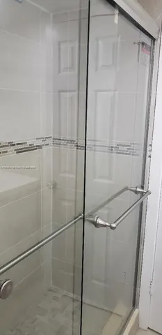 a bathroom with a glass shower door