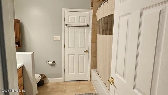 a spacious bedroom with a bed and a window