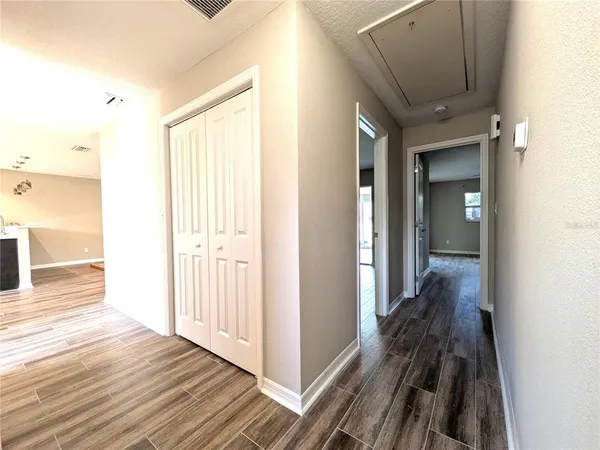 a view of a hallway with wooden floor and staircase