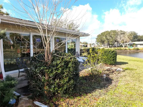 a view of a house with yard and sitting area