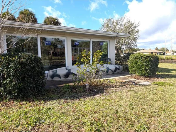 a view of a house with backyard sitting area and garden