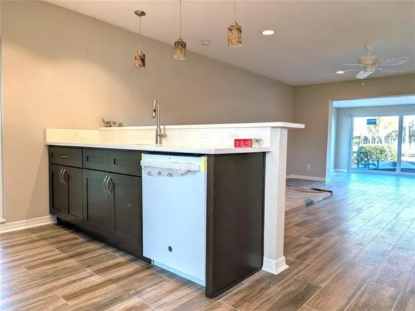 a kitchen with a sink and wooden cabinets