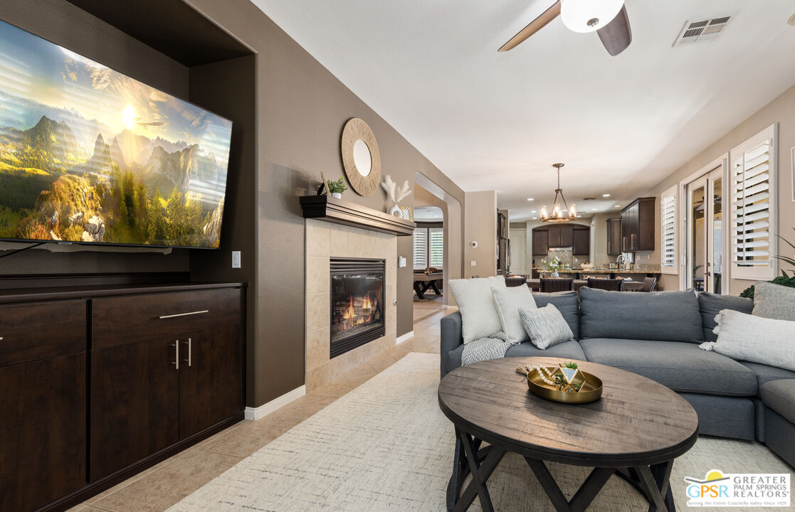80592 Apricot Lane Indio, CA 92201 - Photo 11 of 45 a living room with furniture a flat screen tv and a fireplace